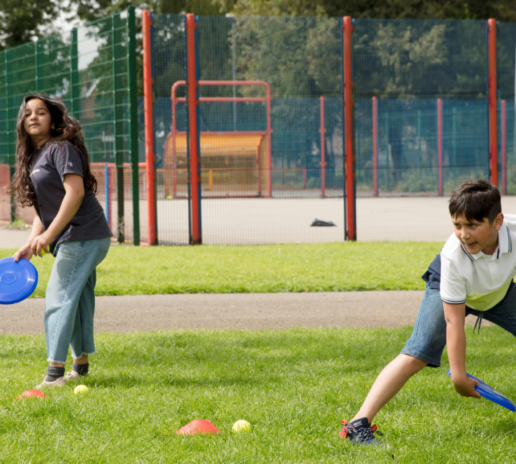 Two children playing with a boomerang