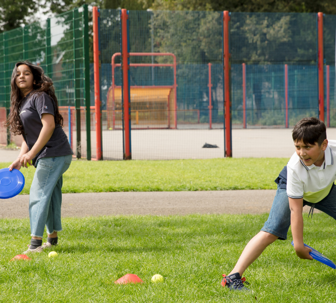 Two children playing with a boomerang