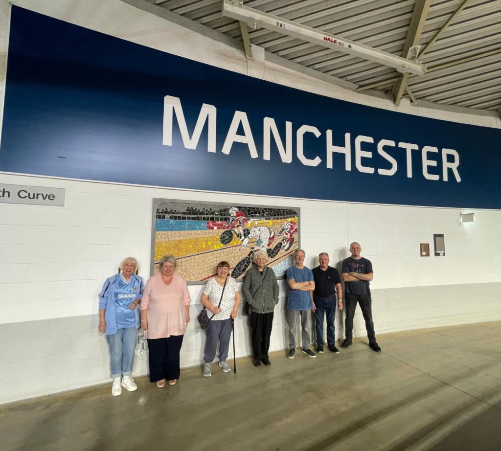 A group standing to pose for a picture at the velodrome