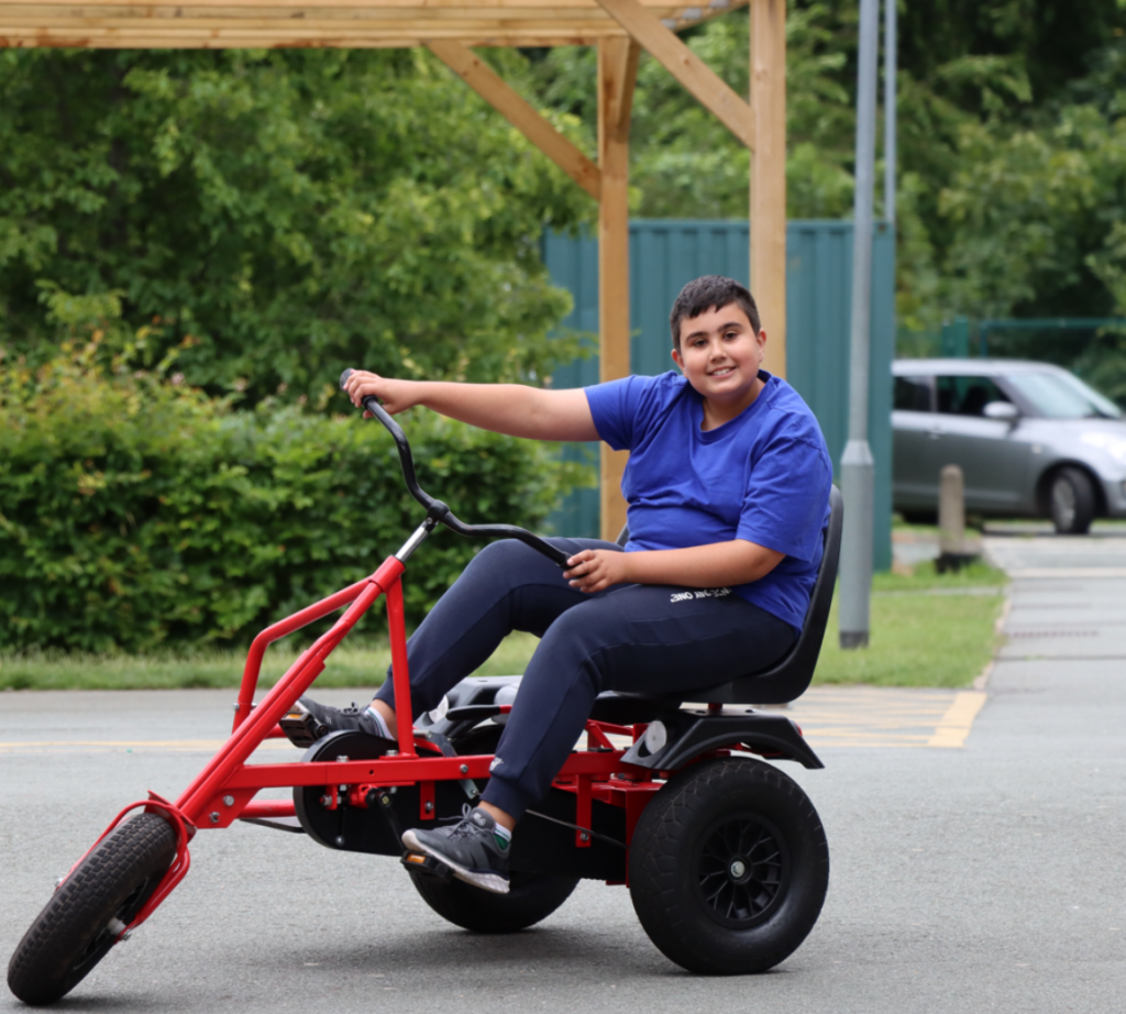 A boy on a tricycle