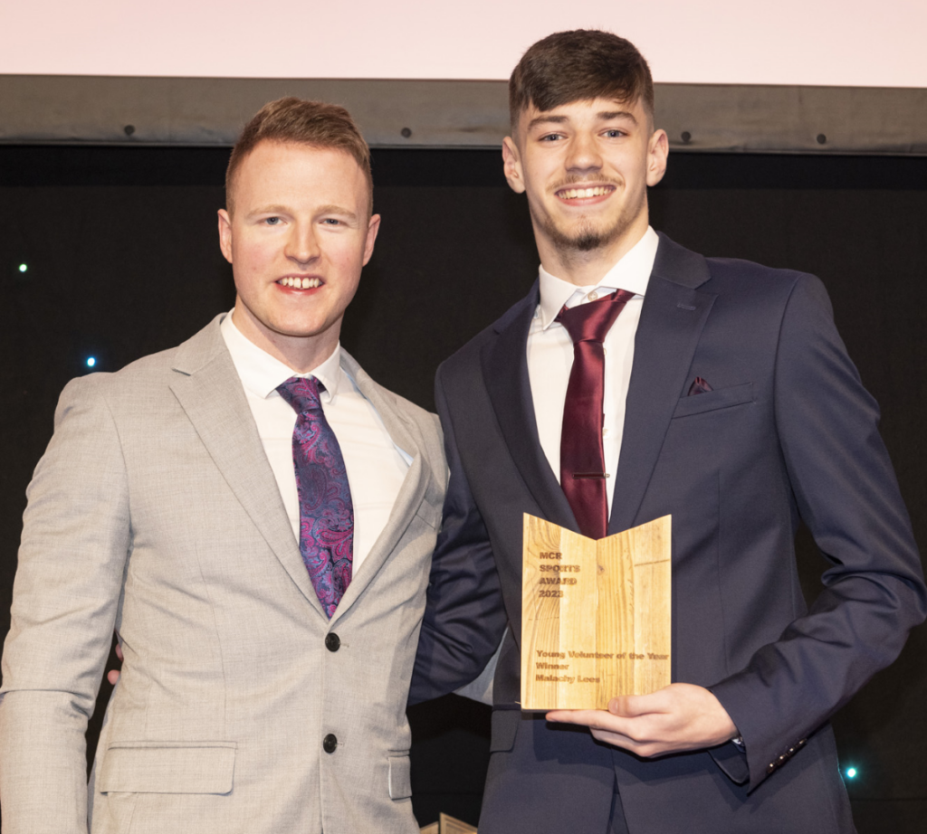 Two men stood with an award