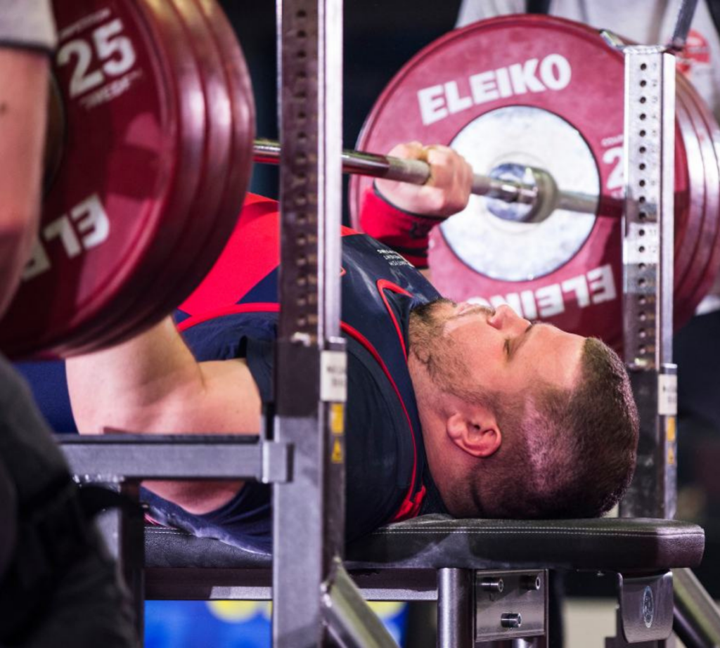 Man bench pressing a heavily weighted bar