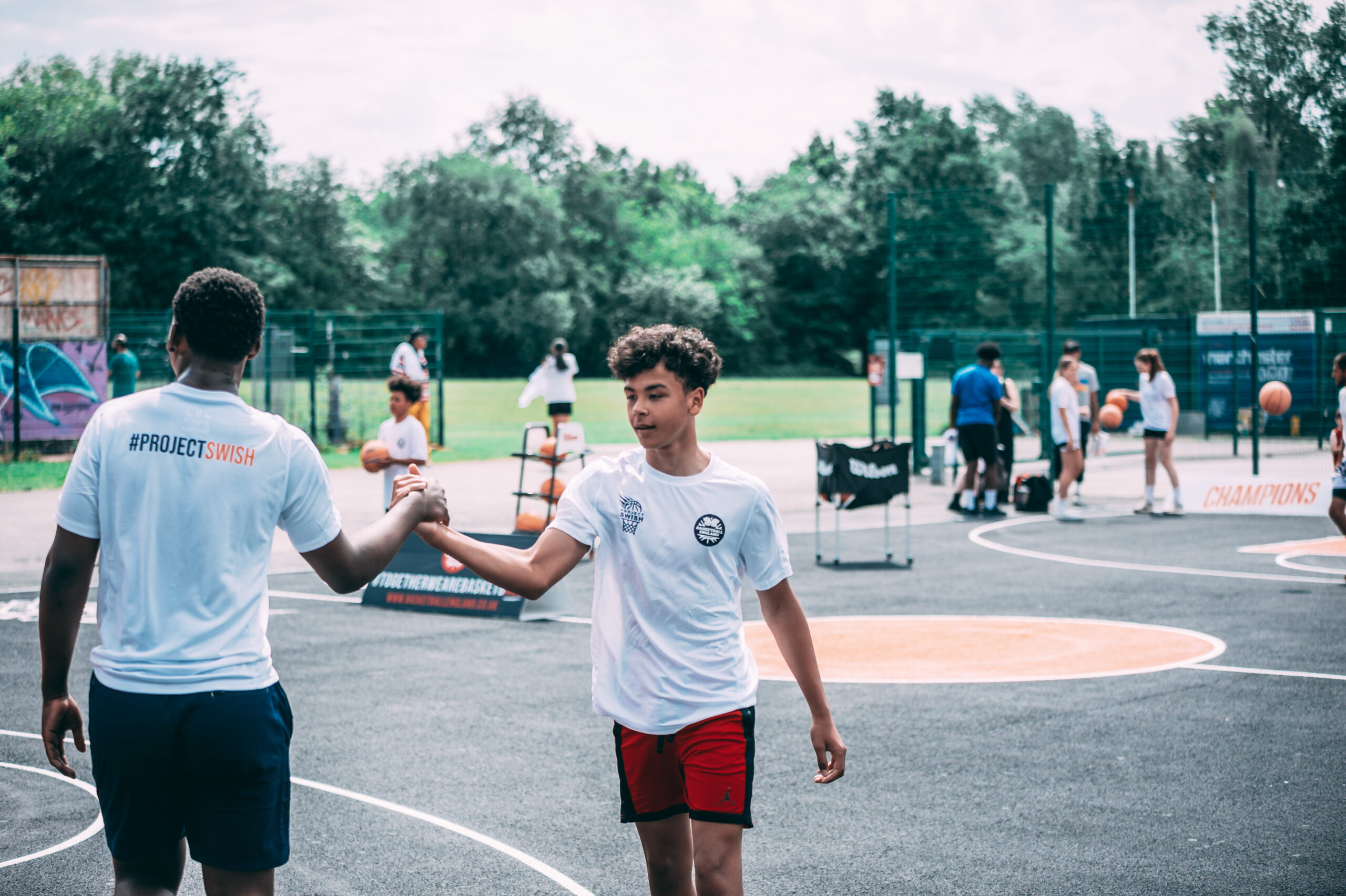 2 noys on a basketball court