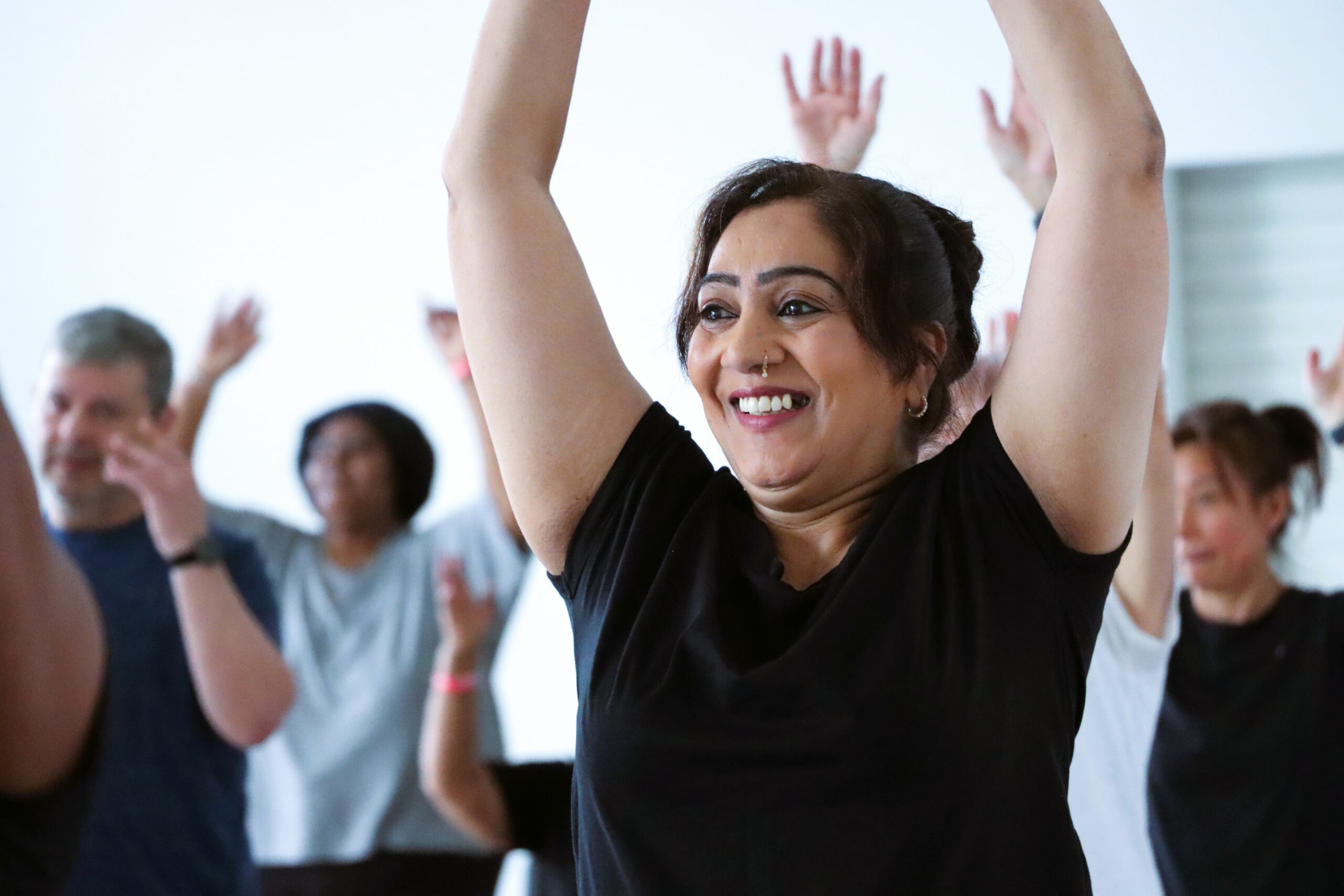 Female dance class - Woman with arms in the air smiling
