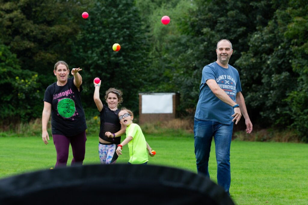 Family throwing cricket balls