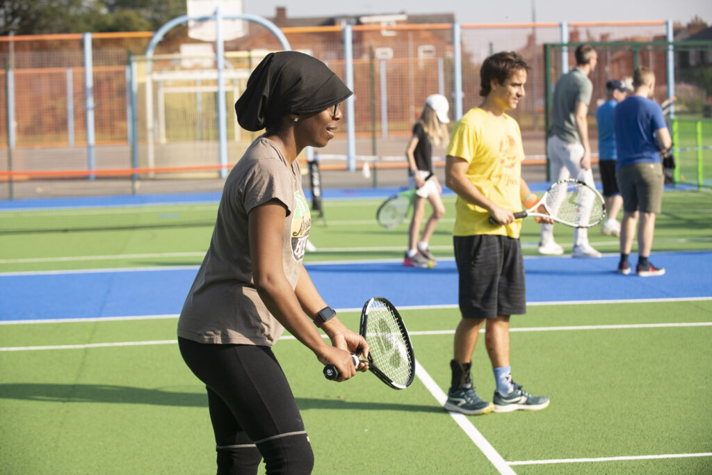 Couple playing outdoor tennis