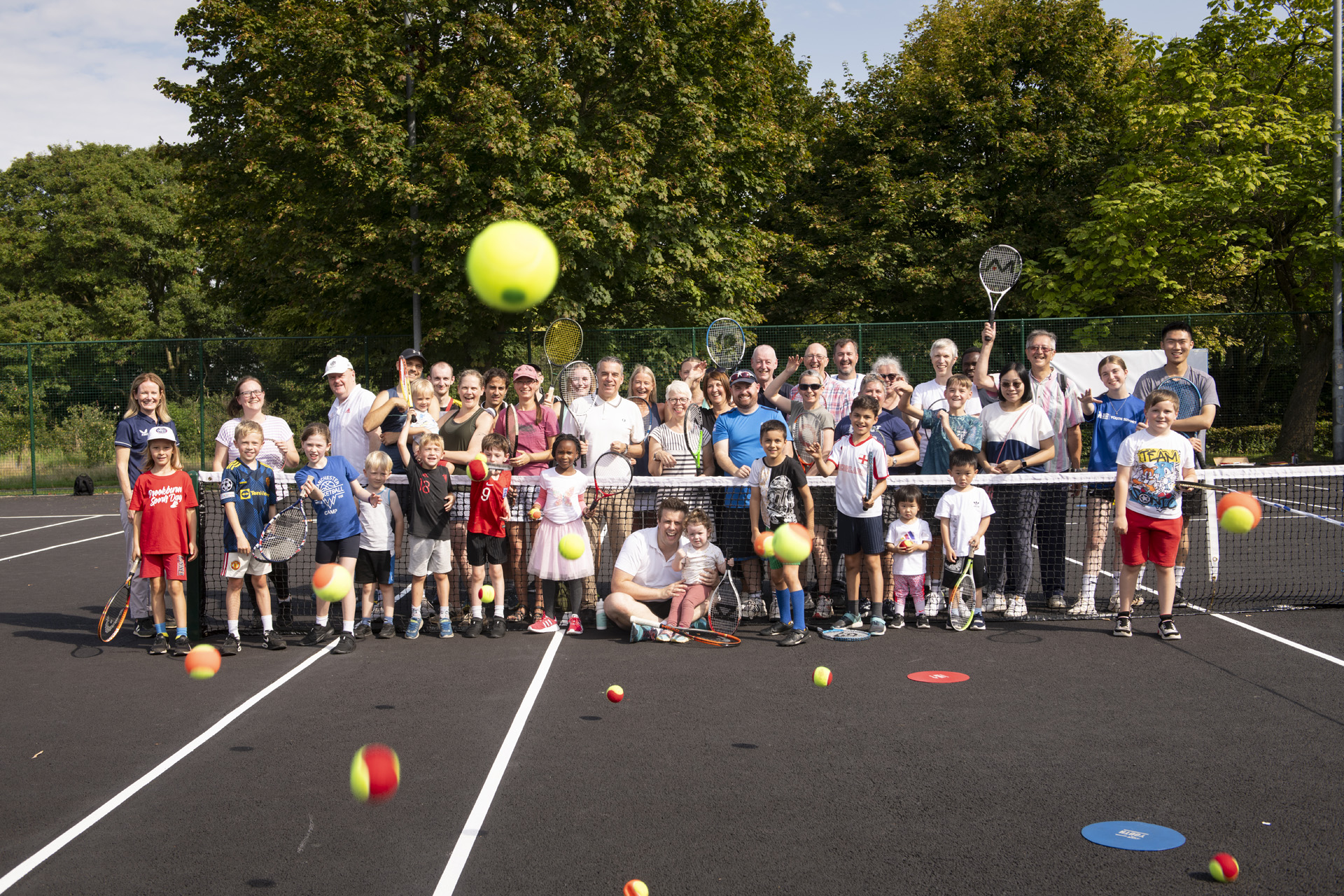 Group of people on a tennis court
