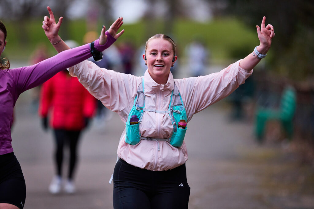 Girl running with arms in the air