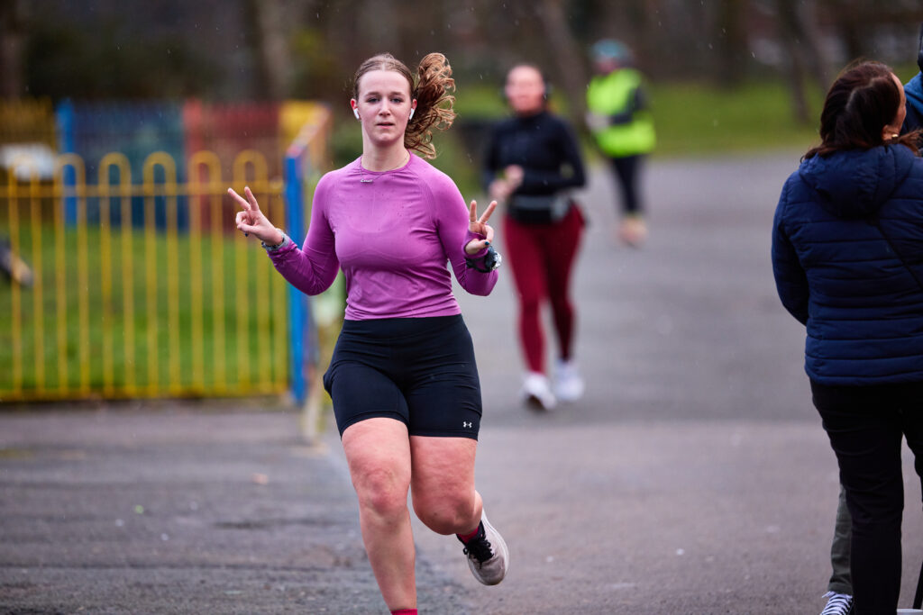 Girl running with arms in the air
