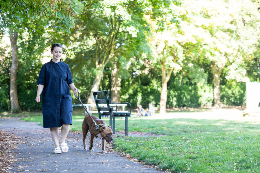 Woman walking dog in park