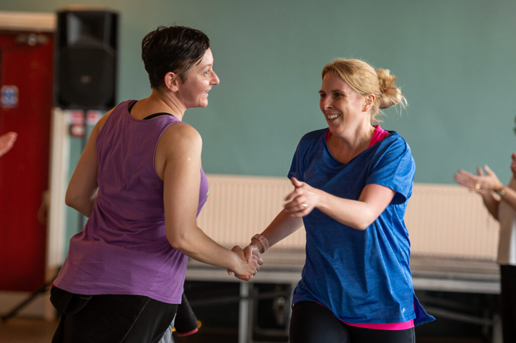 2 Women dancing and smiling