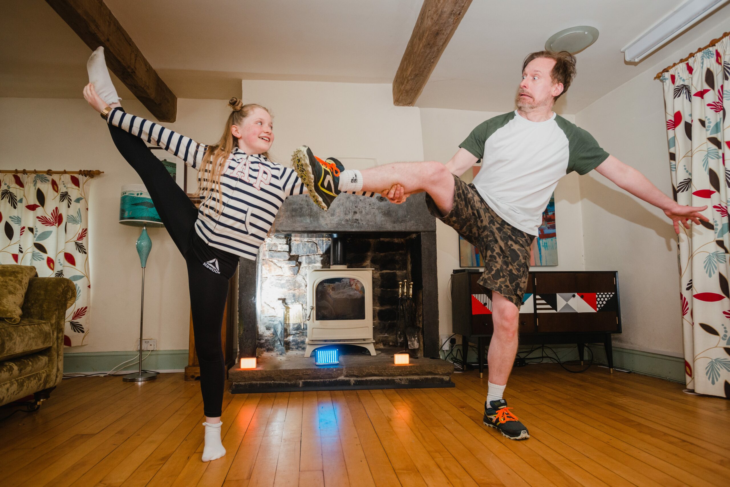 Father and Daughter Exercising in living room