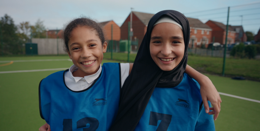 Two school girls on tennis court