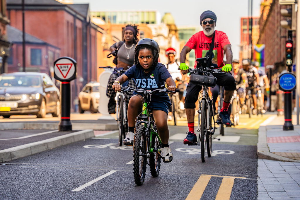 People cycling through centre of manchester