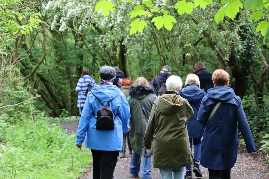 Group of people walking through park