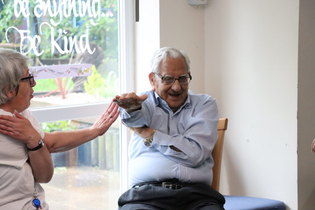 Old man doing chair based exercise